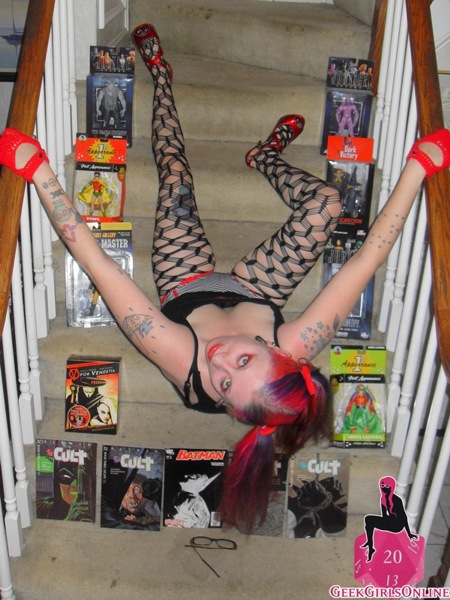 Kinky Art Girl plays on the stairs and shows off her Batman collection in colorful clothing (and then not so much clothing)