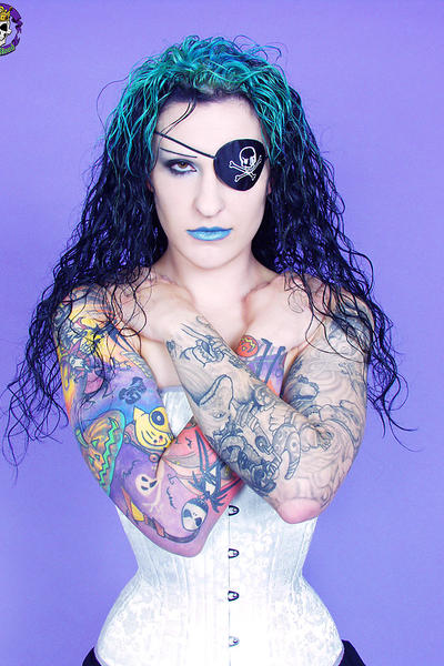 Gothic tattooed pirate girl smirks sexy